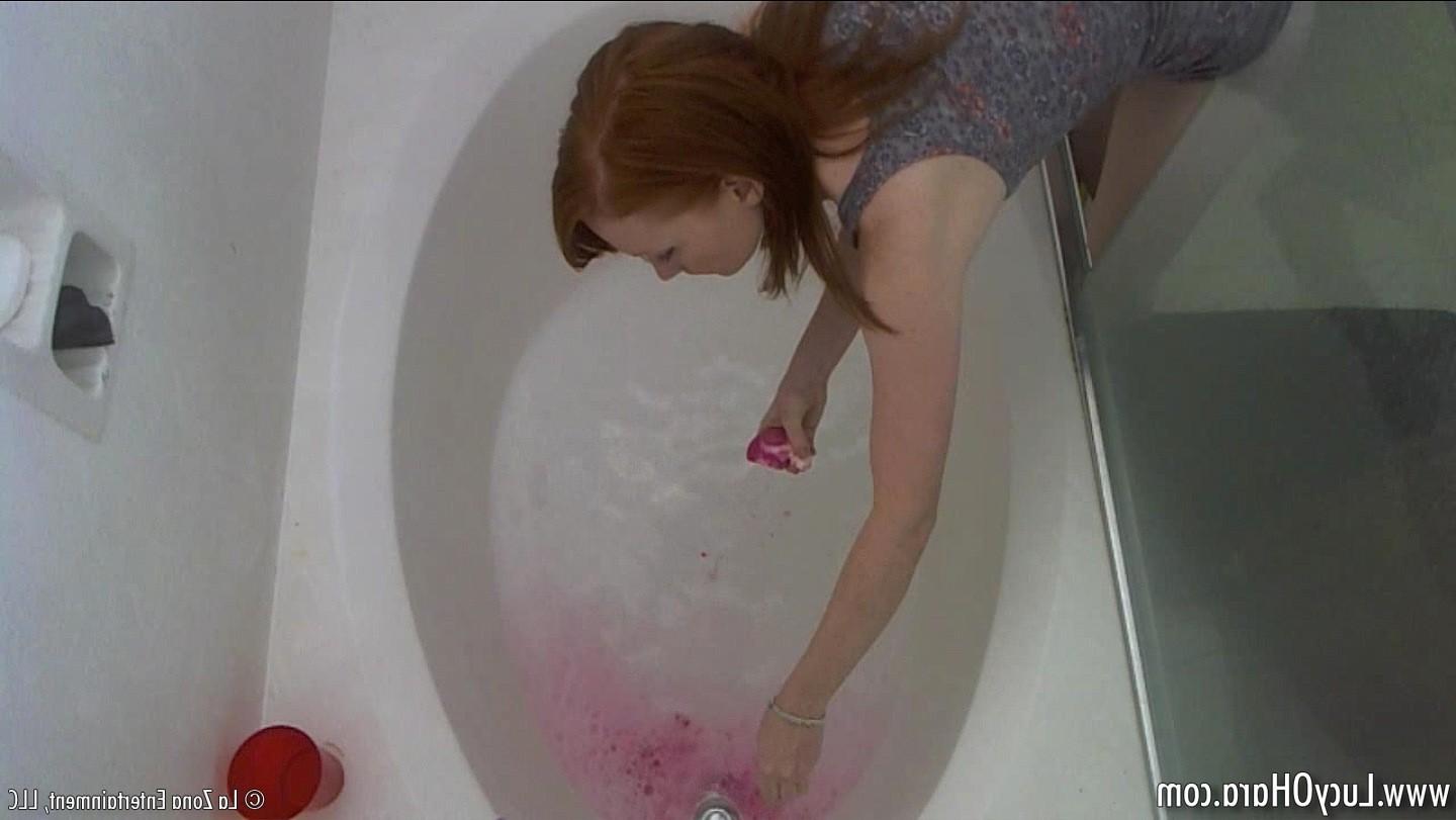15P Busty redhead Lucy bathing