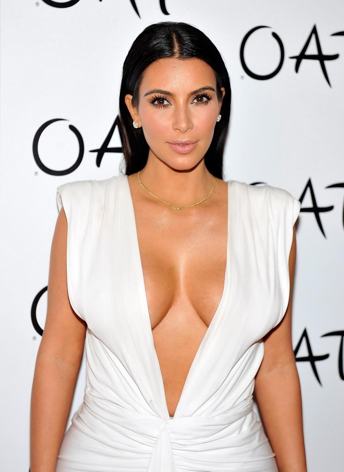 16P Kim Kardashian shows off her huge boobs in a low cut white dress at her birthday