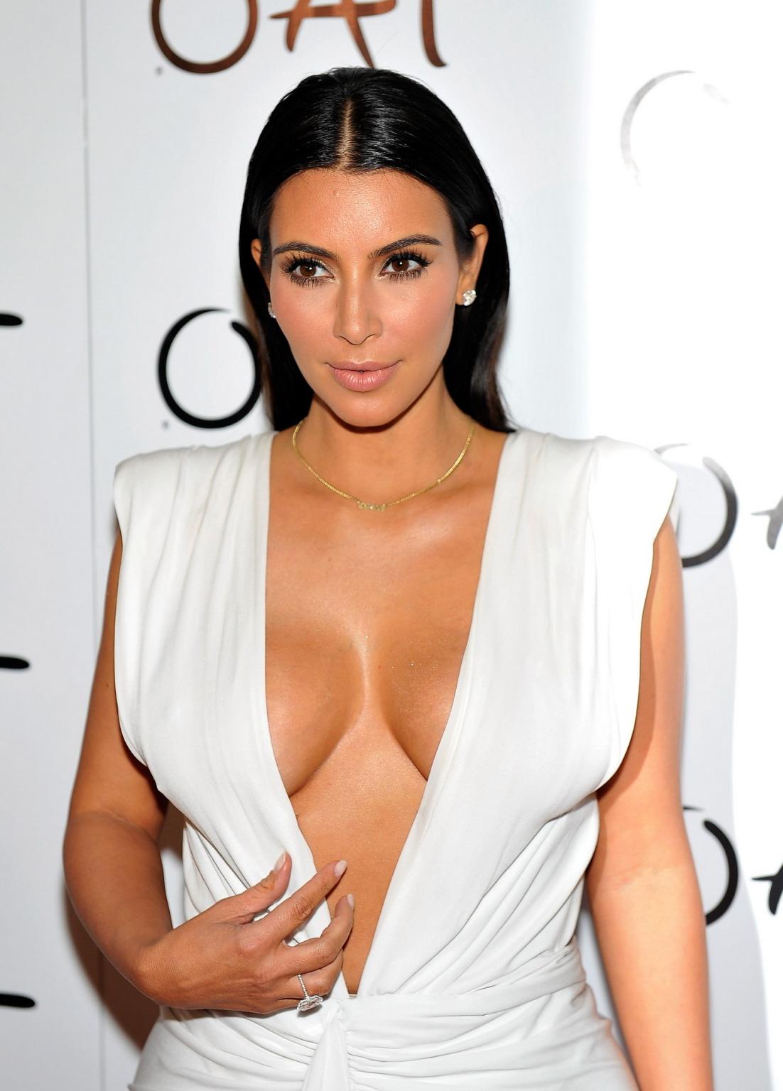 16P Kim Kardashian shows off her huge boobs in a low cut white dress at her birthday