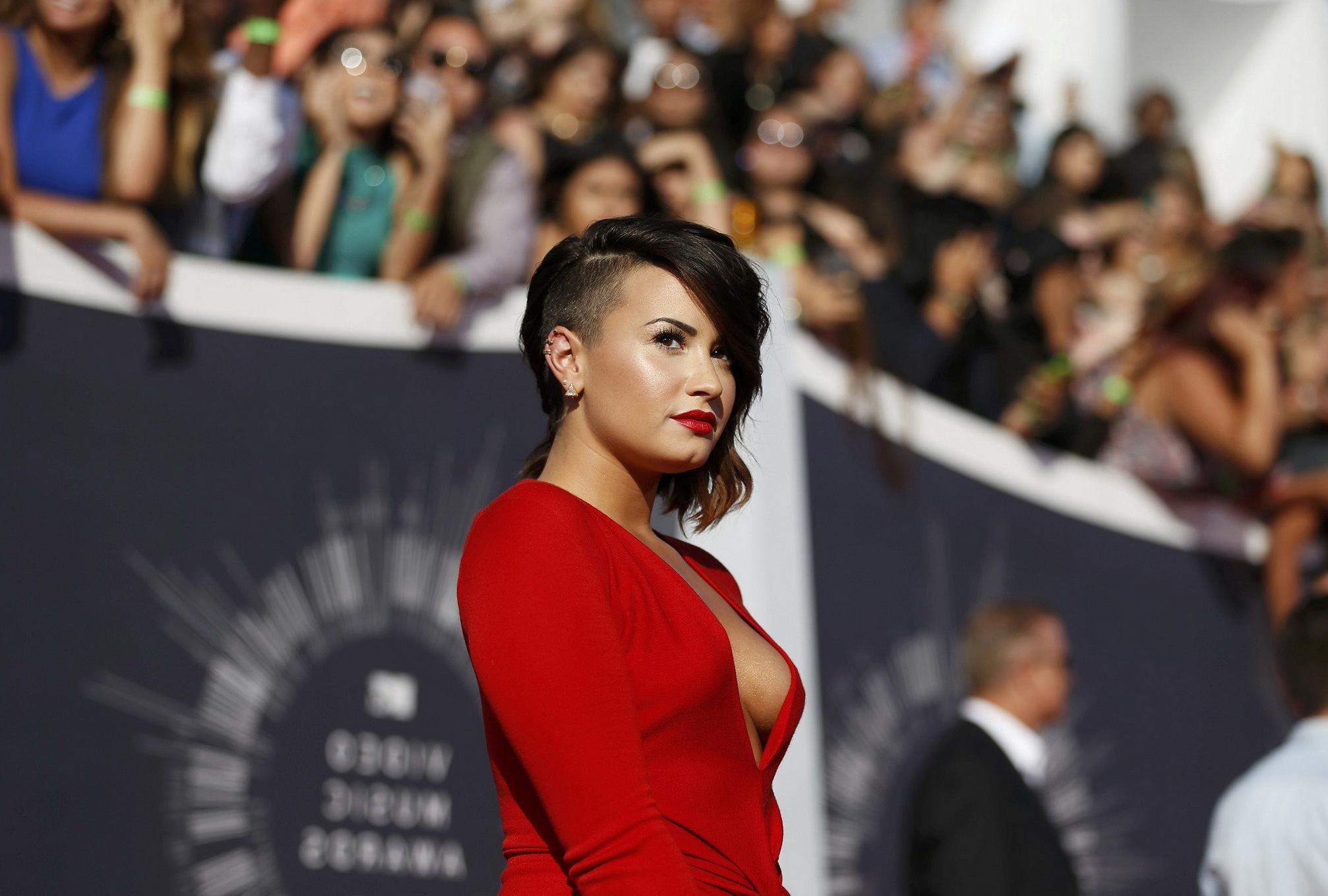 16P Demi Lovato braless in a low cut  high slit red dress at 2014 MTV Video Music Aw