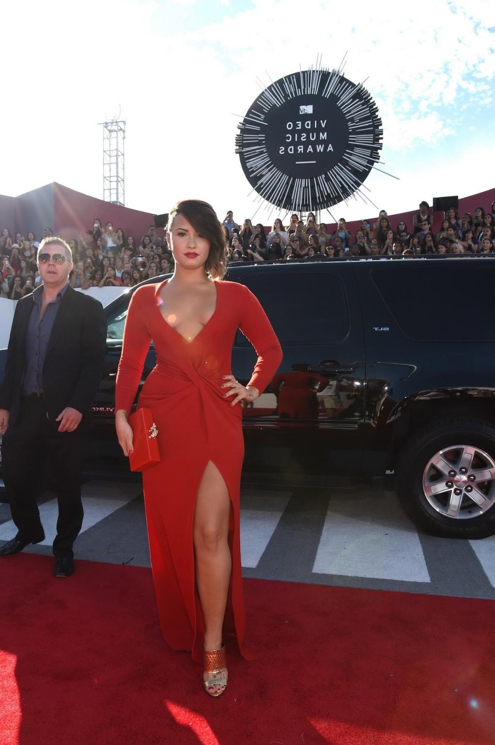 16P Demi Lovato braless in a low cut  high slit red dress at 2014 MTV Video Music Aw
