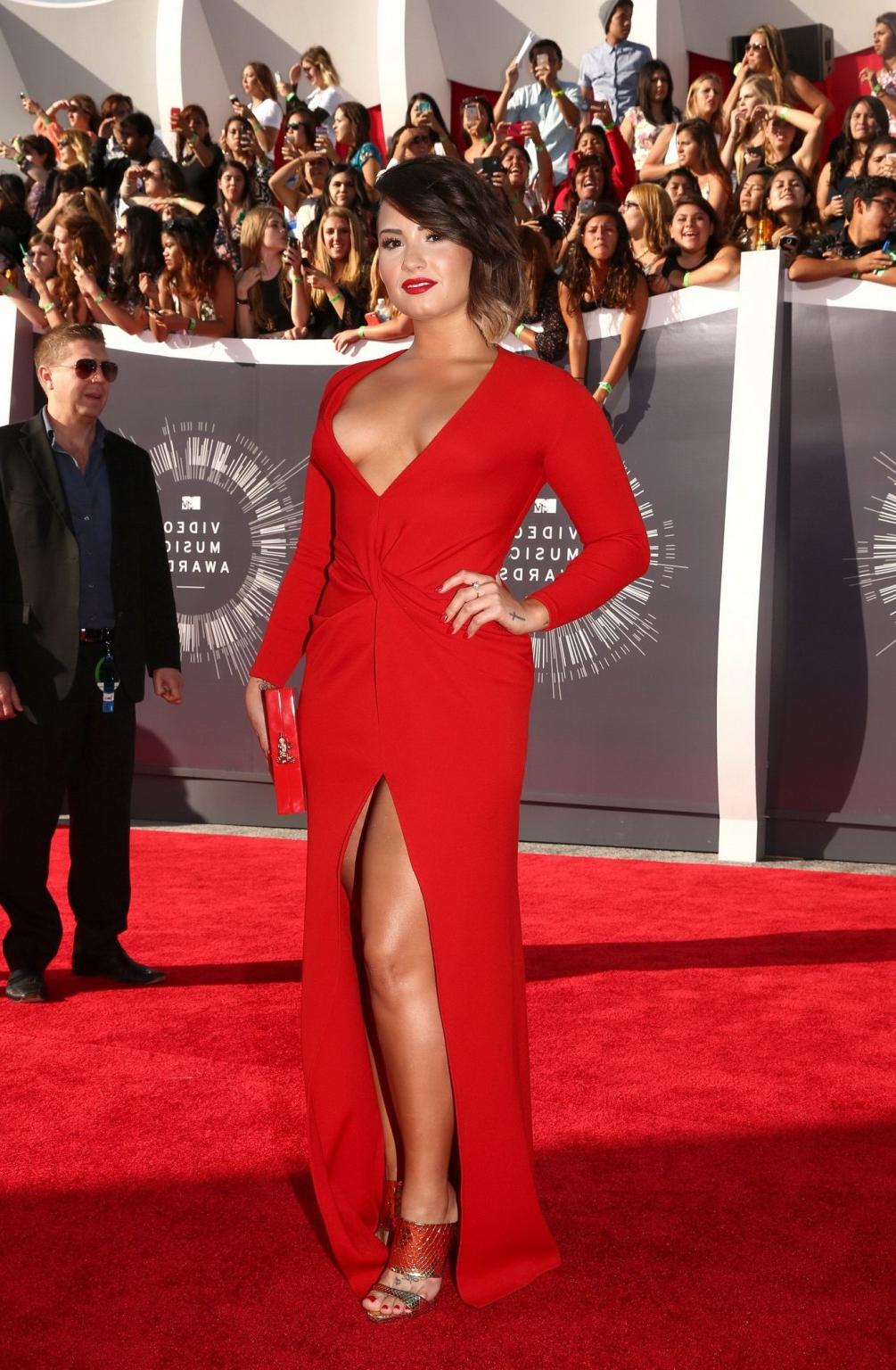 16P Demi Lovato braless in a low cut  high slit red dress at 2014 MTV Video Music Aw