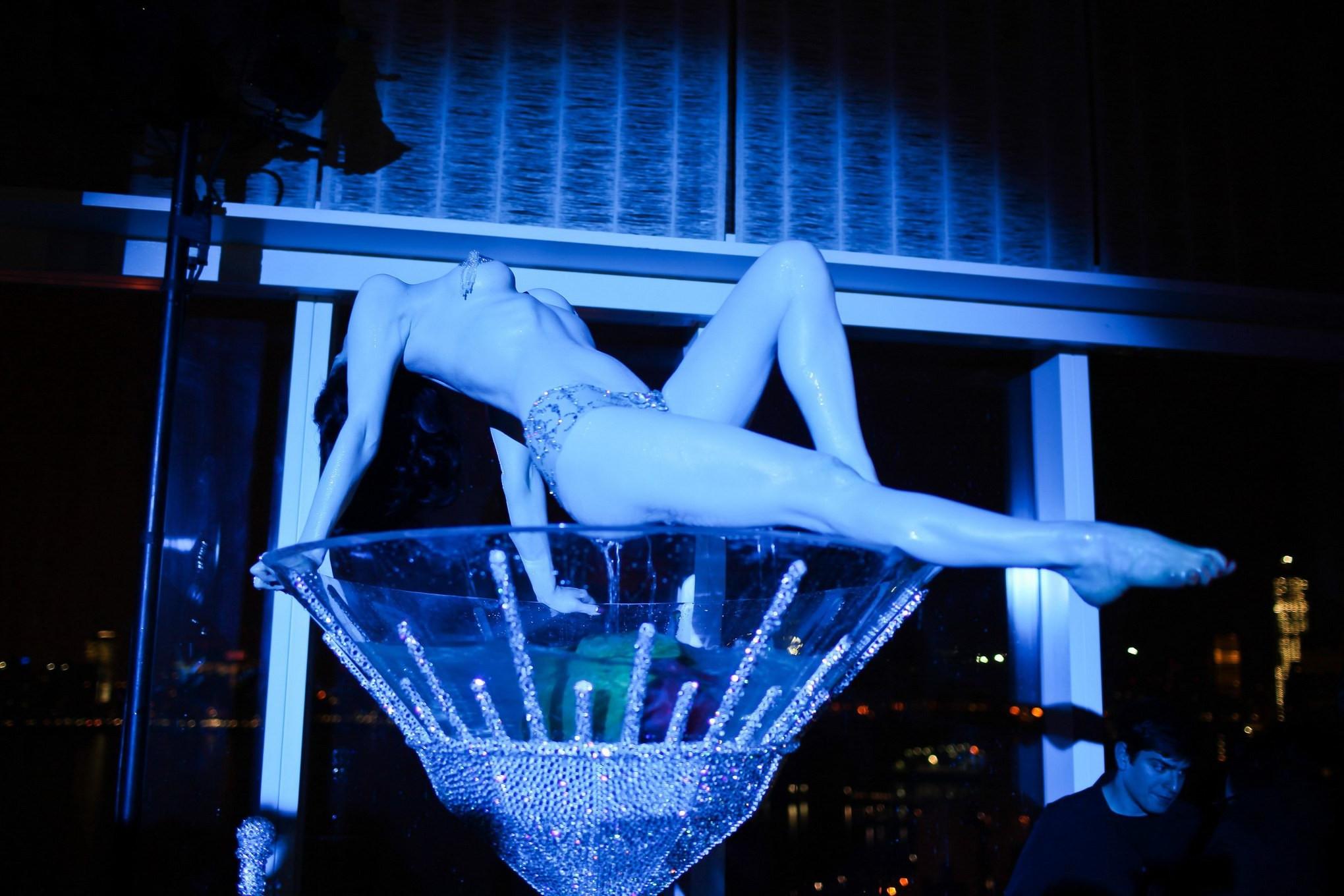 16P Dita Von Teese wearing nip stickers  thong while bathing in a giant martini glas