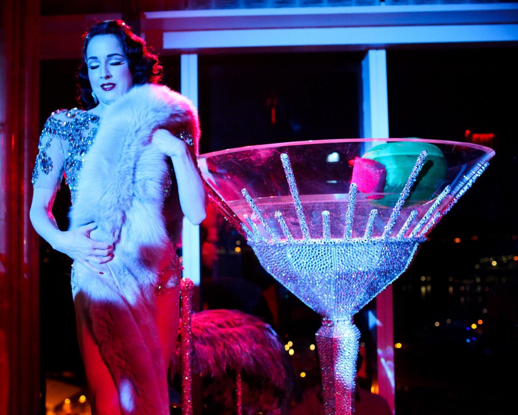 16P Dita Von Teese wearing nip stickers  thong while bathing in a giant martini glas