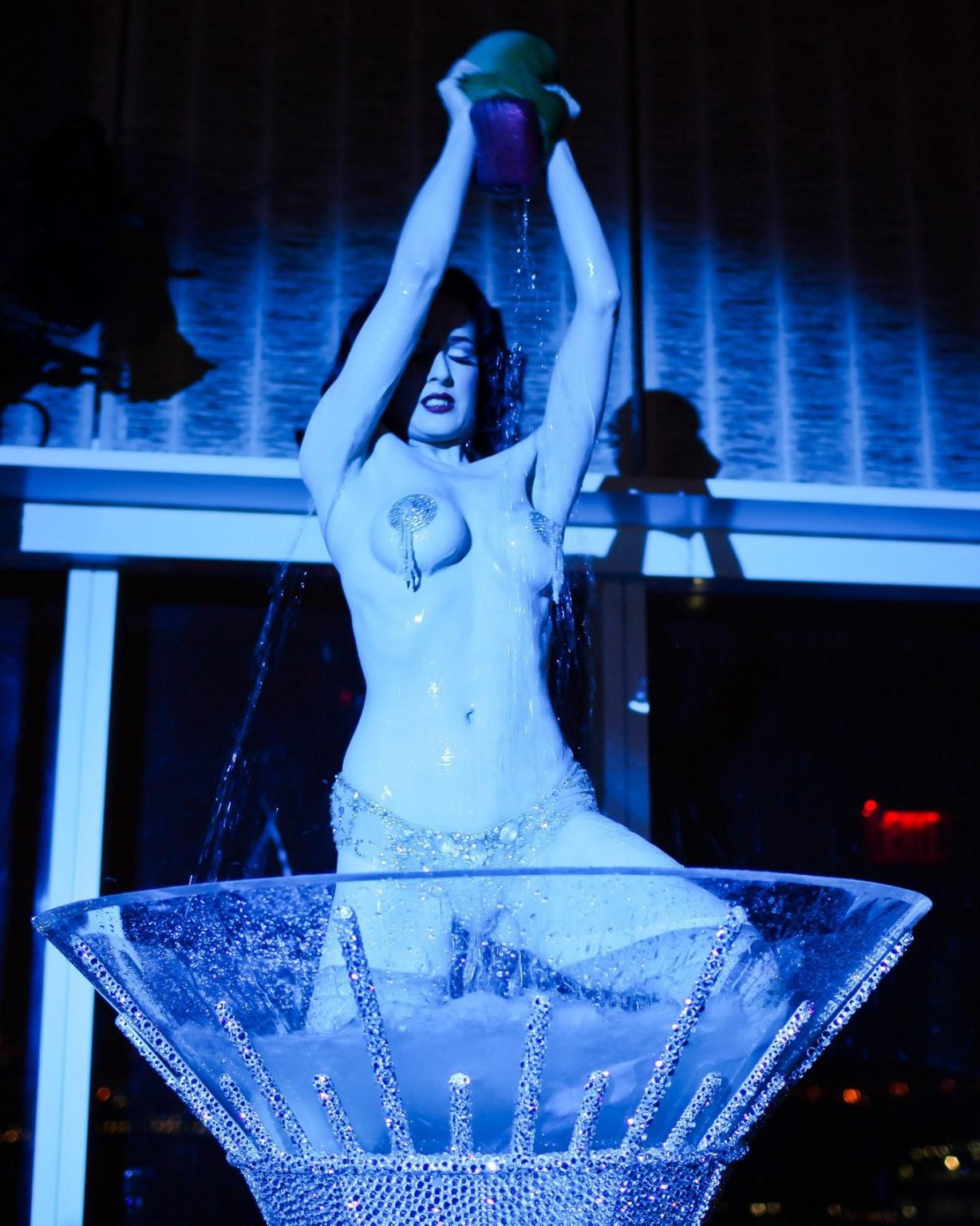 16P Dita Von Teese wearing nip stickers  thong while bathing in a giant martini glas