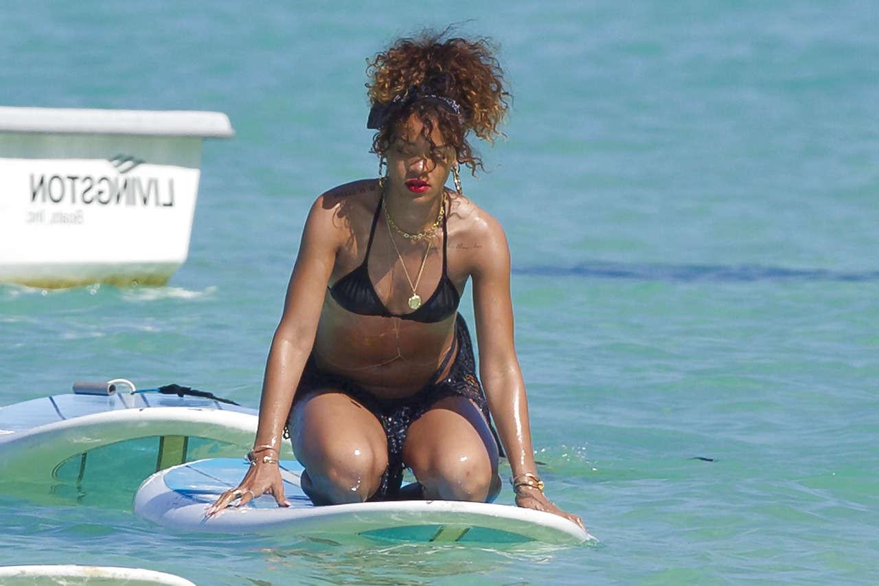 16P Rihanna showing her great ass in black thong on beach paparazzi photos