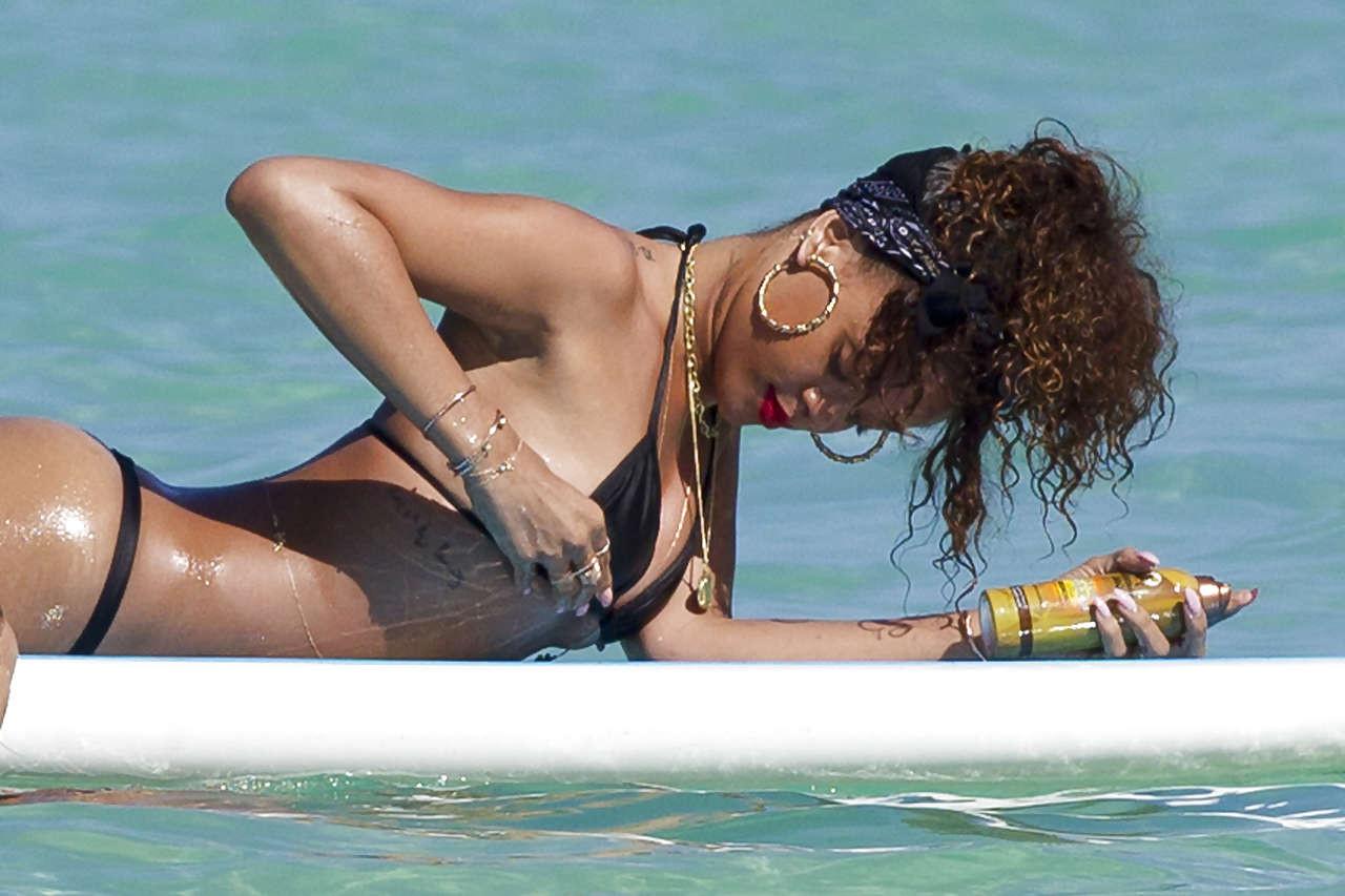 16P Rihanna showing her great ass in black thong on beach paparazzi photos