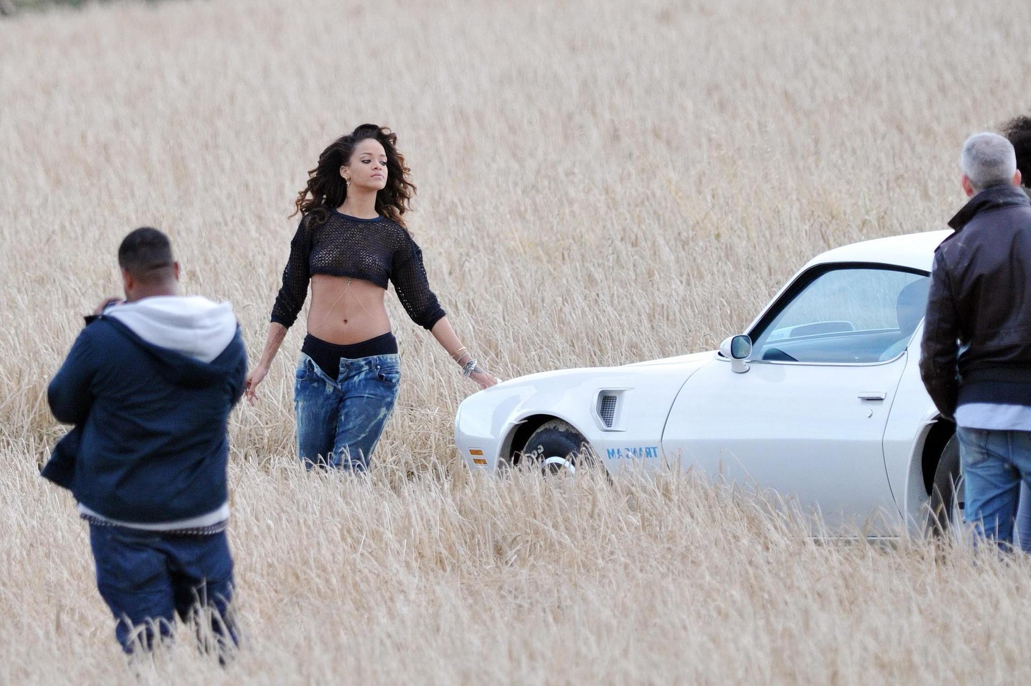 16P Rihanna braless in see through top shooting a music video in Ireland