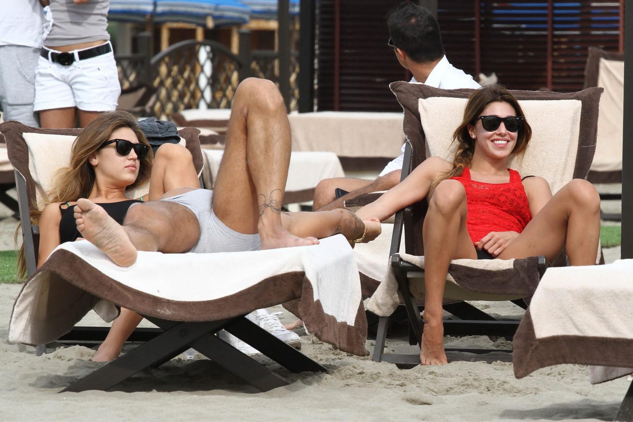 16P Belen Rodriguez shows off her ass wearing thong bikini on a beach in Forte Dei M
