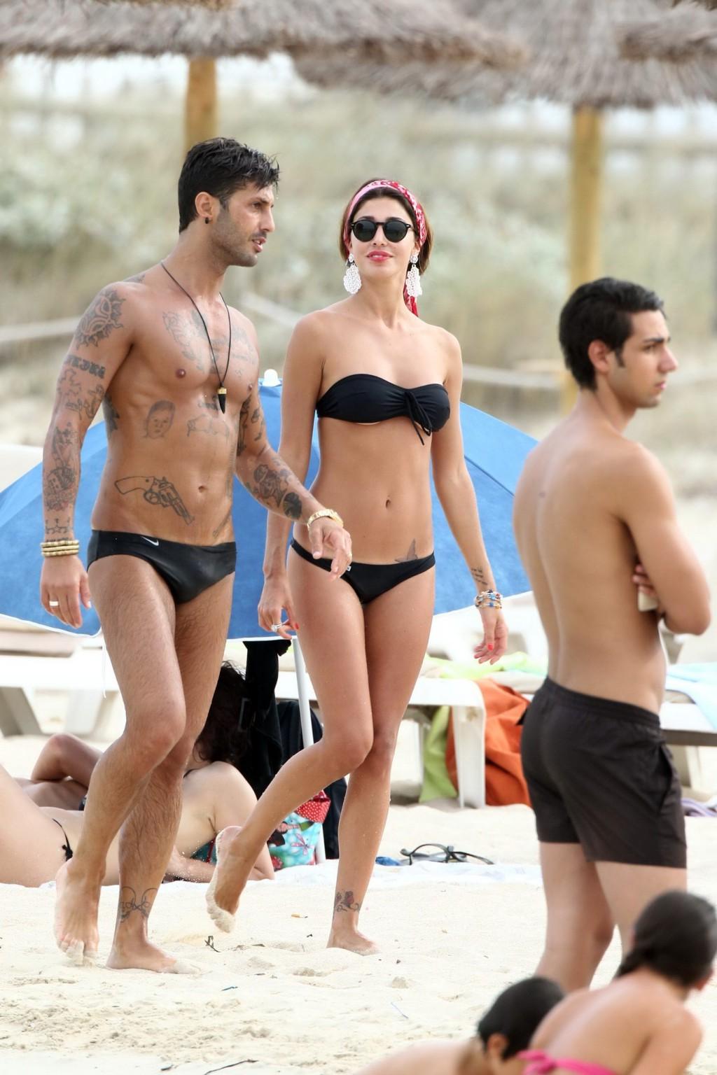 16P Belen Rodriguez shows off her ass wearing black thong bikini on the beach in For