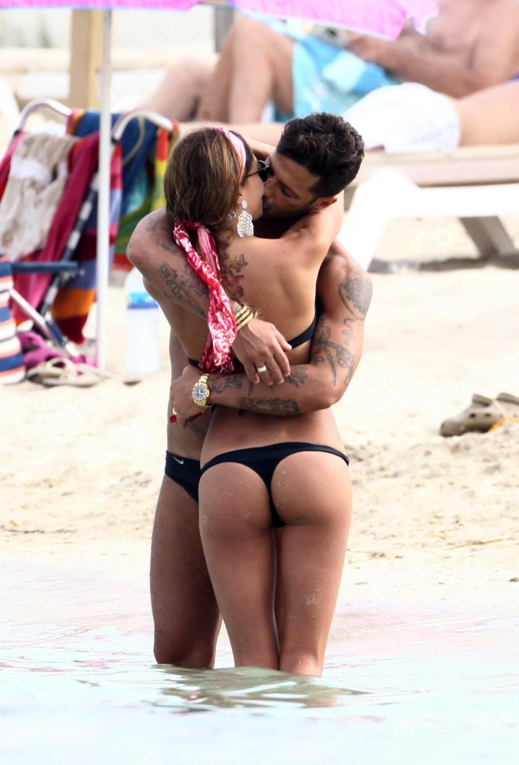 16P Belen Rodriguez shows off her ass wearing black thong bikini on the beach in For
