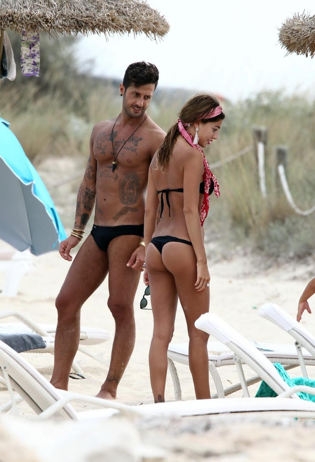 16P Belen Rodriguez shows off her ass wearing black thong bikini on the beach in For