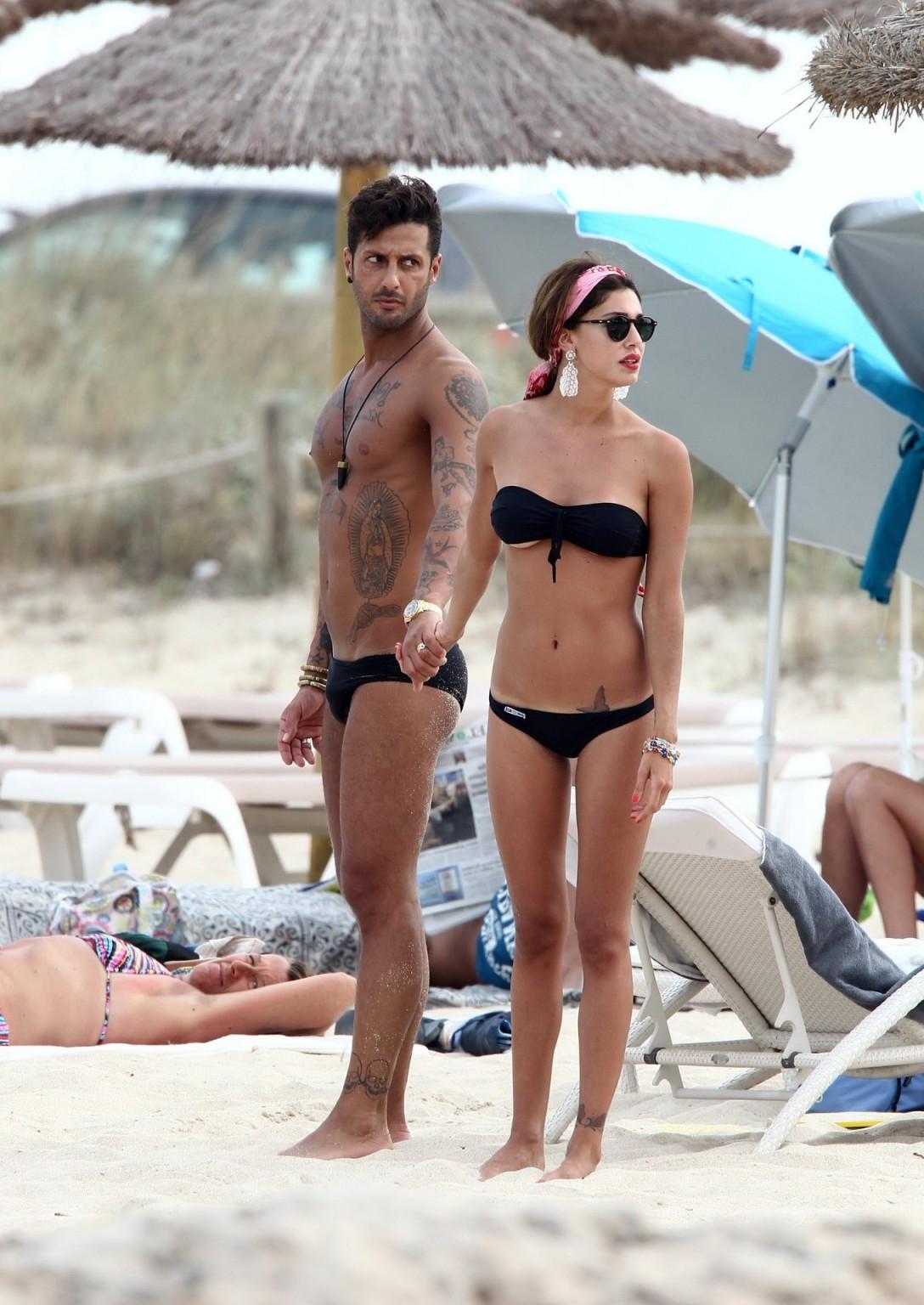 16P Belen Rodriguez shows off her ass wearing black thong bikini on the beach in For