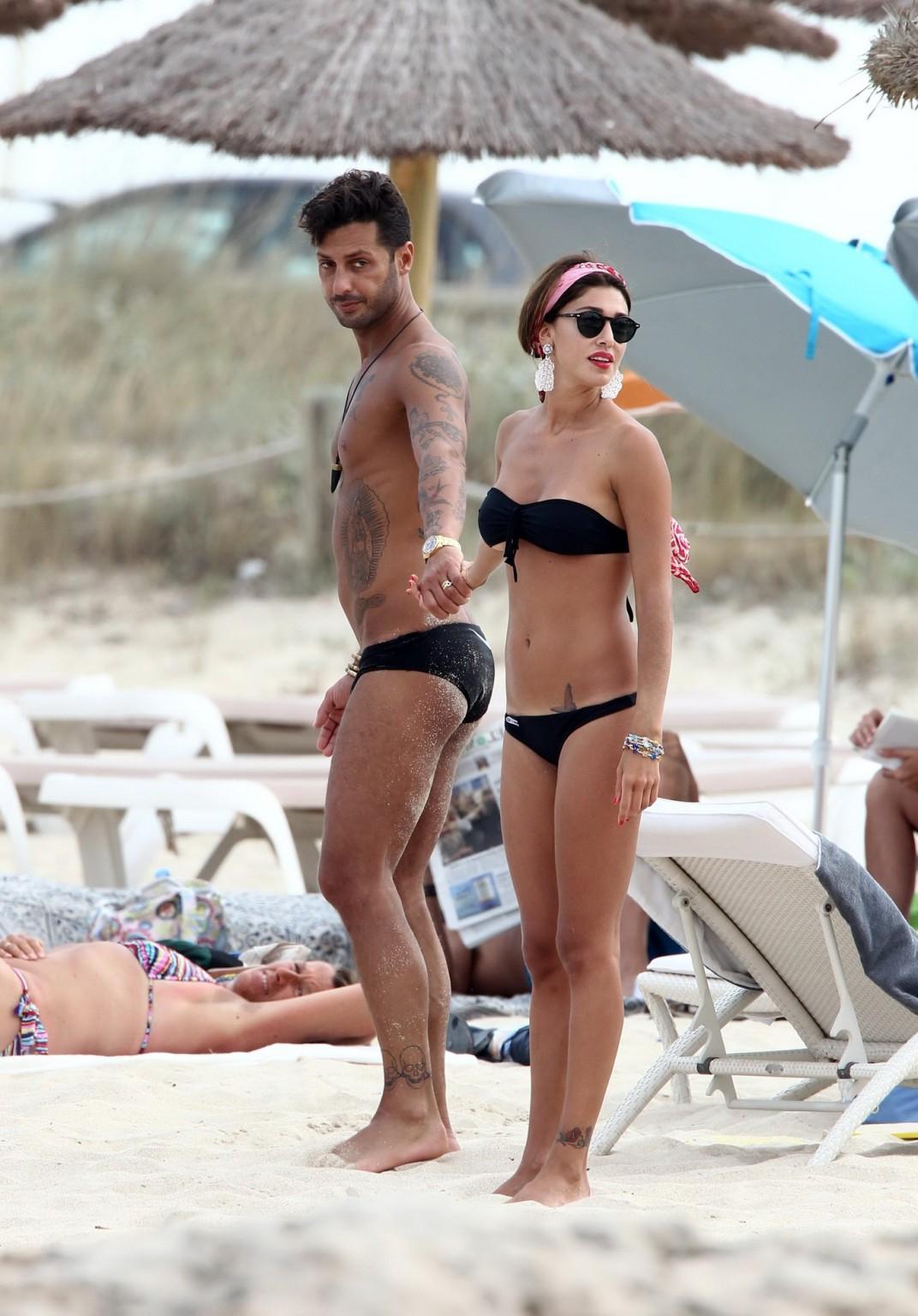 16P Belen Rodriguez shows off her ass wearing black thong bikini on the beach in For