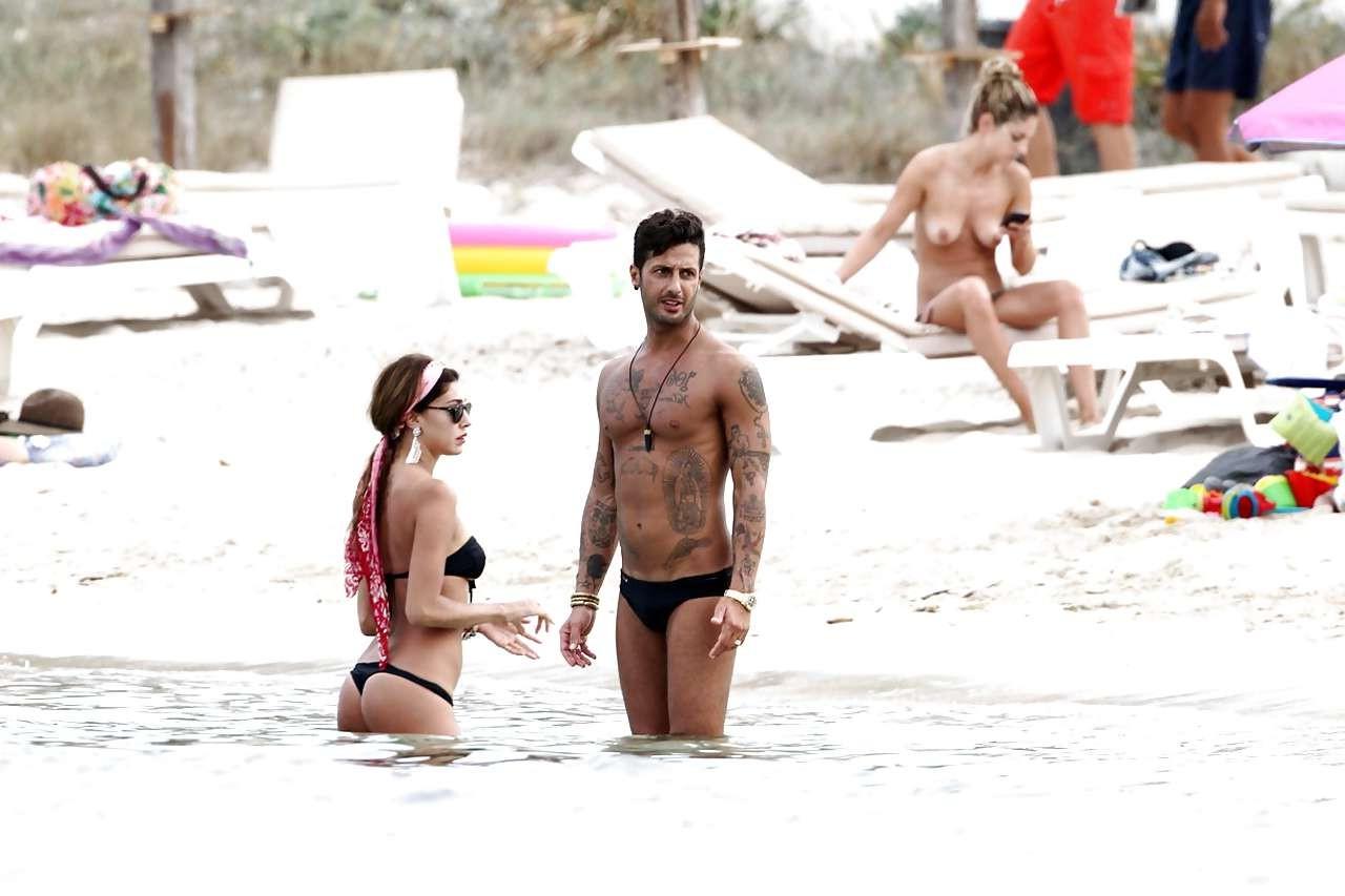 16P Belen Rodriguez showing her fantastic ass in black thong bikini on beach