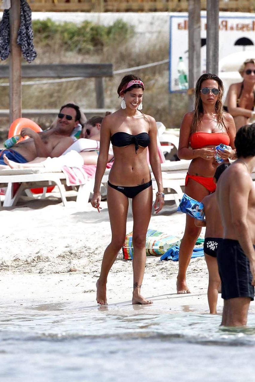 16P Belen Rodriguez showing her fantastic ass in black thong bikini on beach