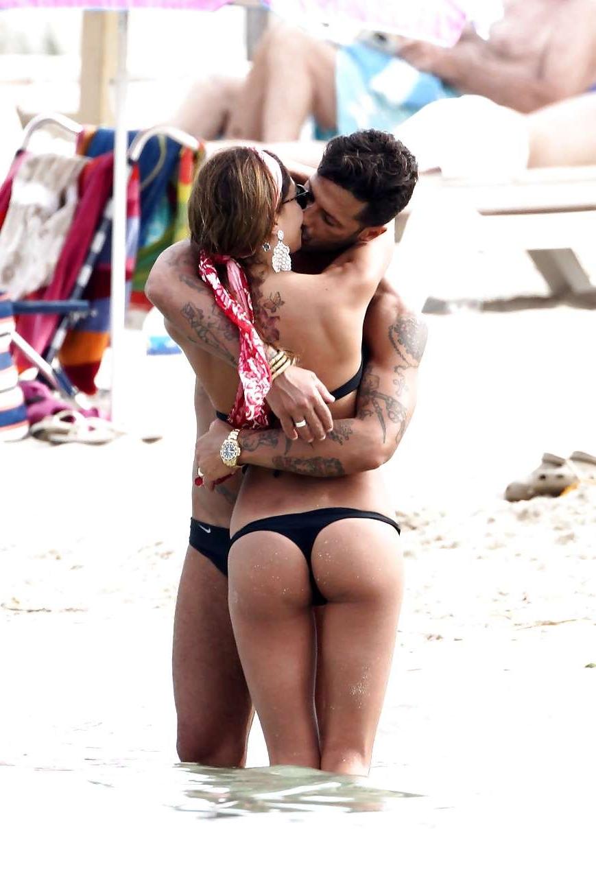 16P Belen Rodriguez showing her fantastic ass in black thong bikini on beach