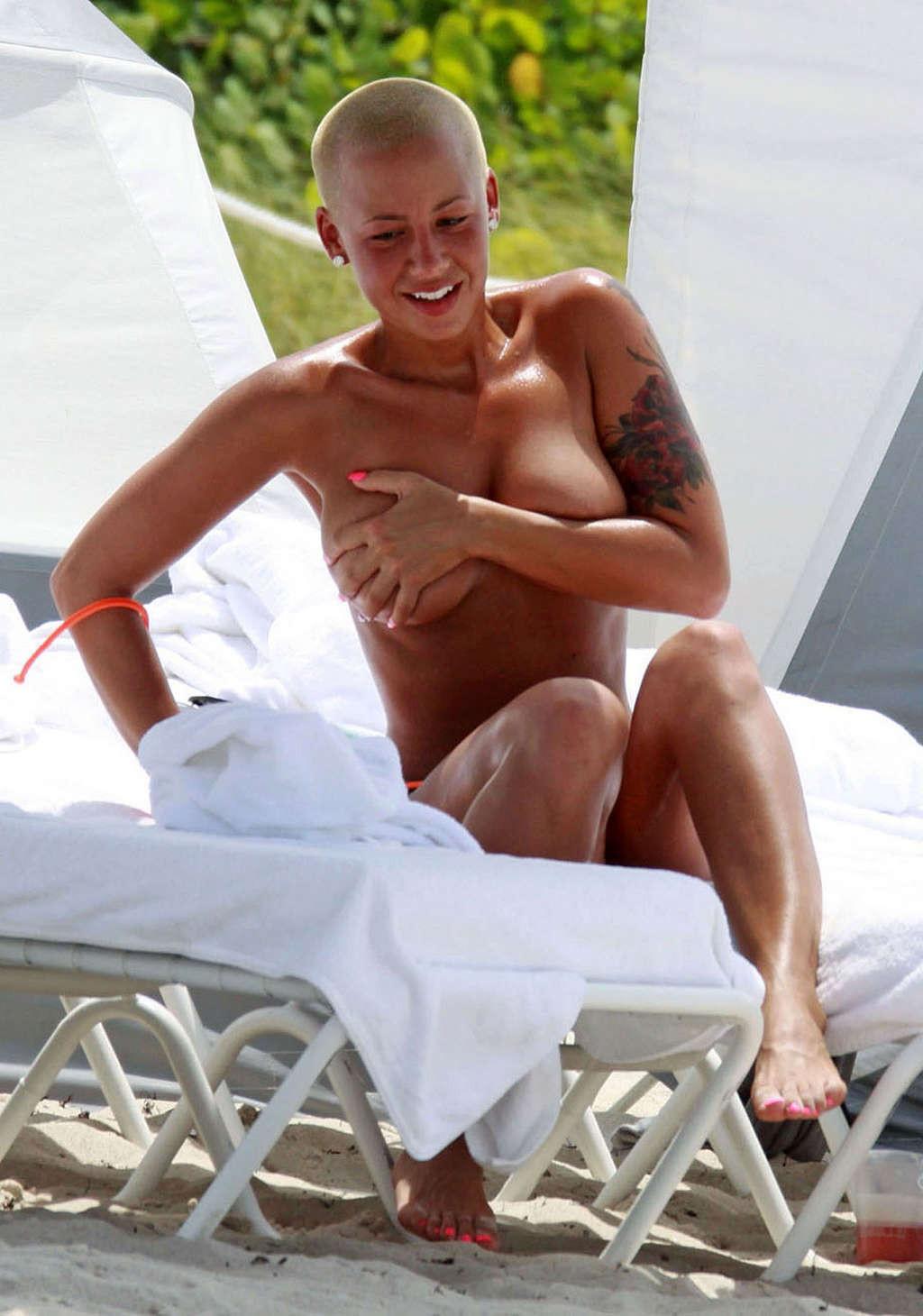 16P Amber Rose posing and showing extremely hot and sexy ass in thong