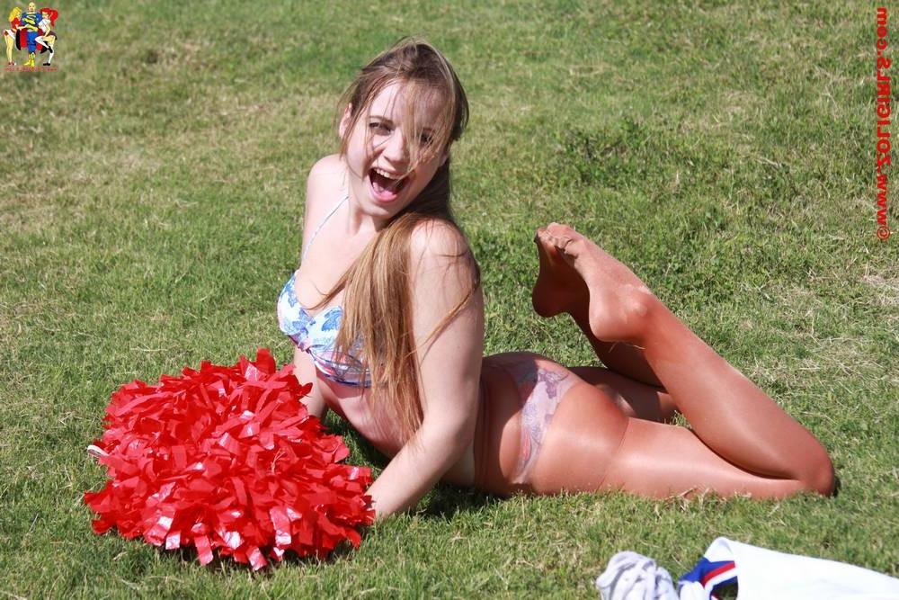15P Cute cheerleader posing outside in her pantyhose