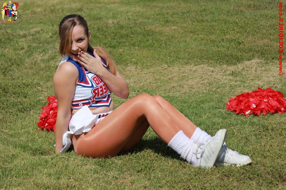15P Cute cheerleader posing outside in her pantyhose