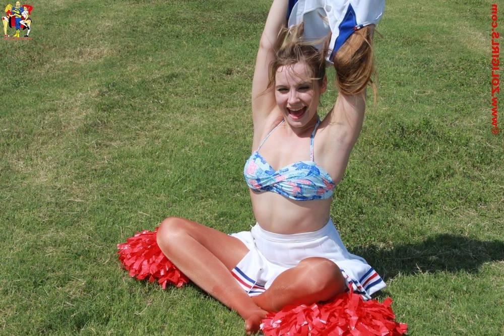 15P Cute cheerleader posing outside in her pantyhose