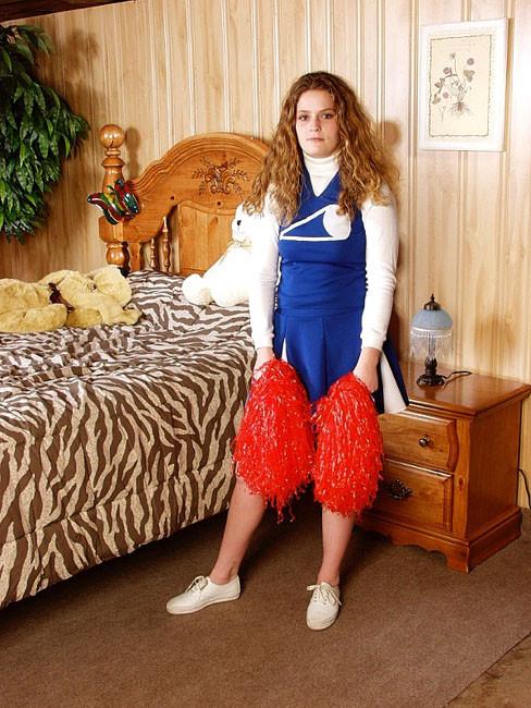 13P Curly Cheerleader showing her perky boobies