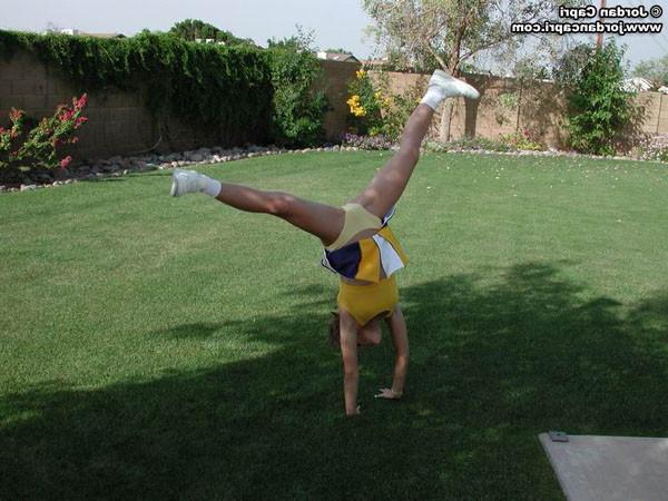 20P Brunette cheerleader posing outdoors