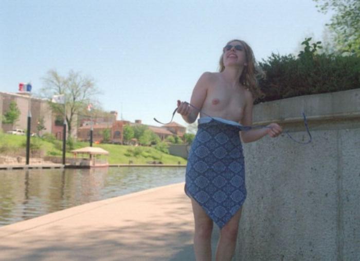 20P Curly blonde shows her tits outdoor