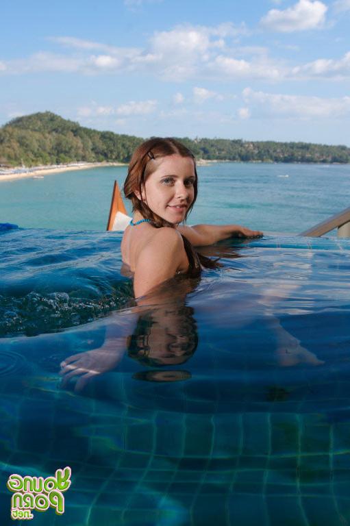 15P Young brunette posing in a private pool