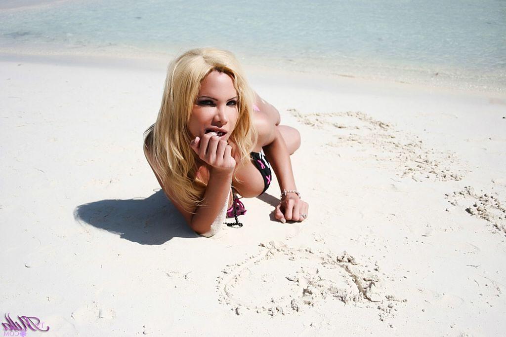 12P Curvy Argentine shemale hits the beach in her bikini
