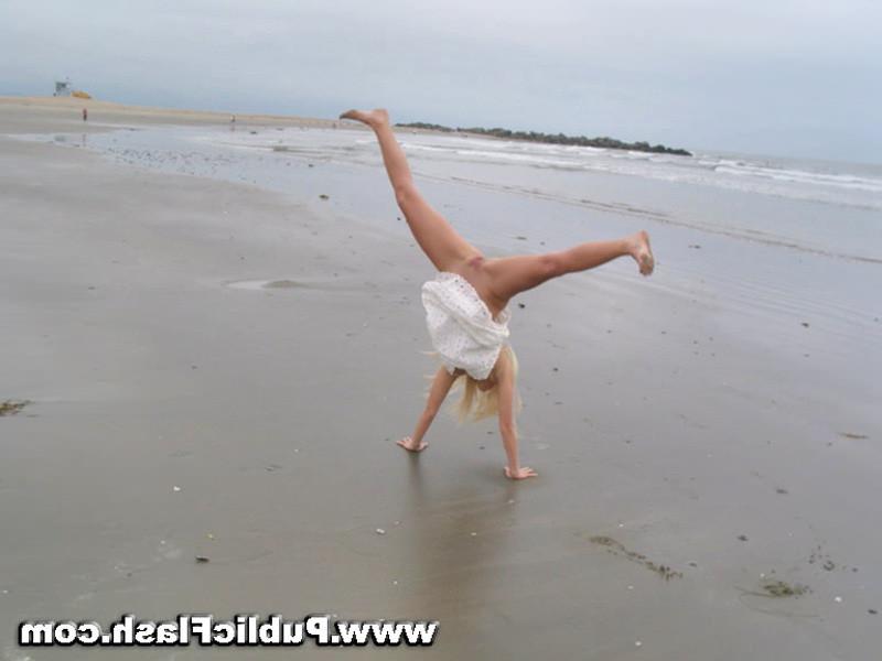 16P Daring blonde babe flashing pantyless upskirts on public beach