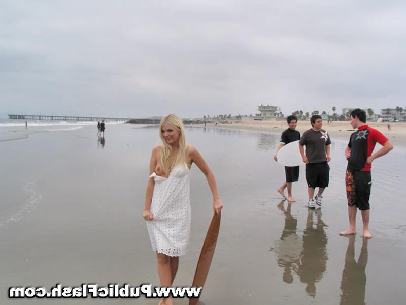 16P Daring blonde babe flashing pantyless upskirts on public beach