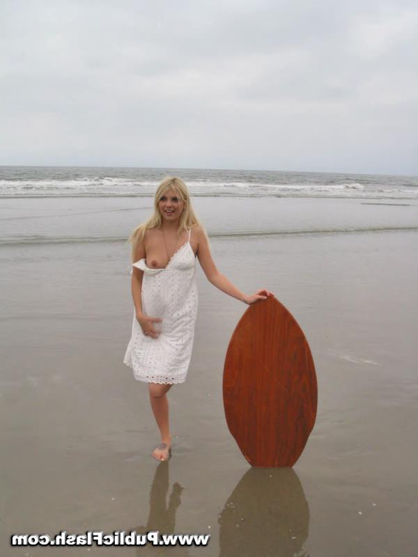 16P Daring blonde babe flashing pantyless upskirts on public beach