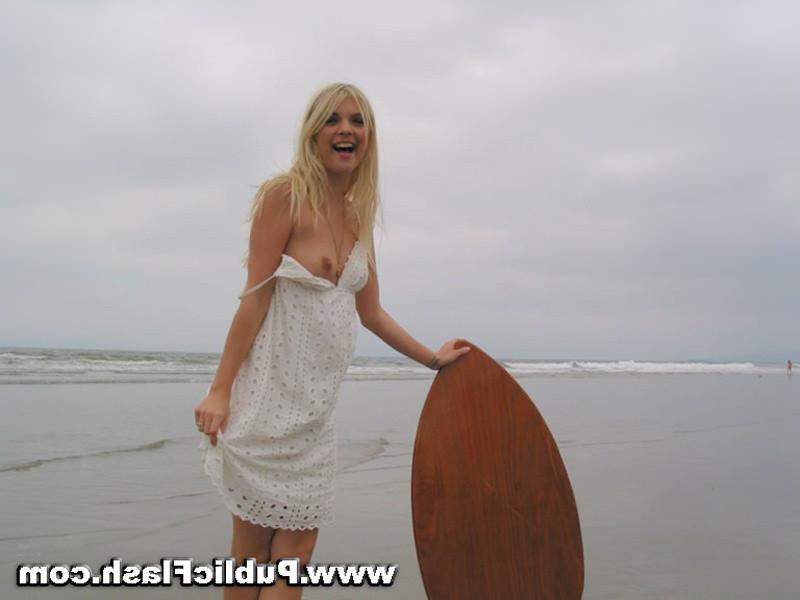 16P Daring blonde babe flashing pantyless upskirts on public beach