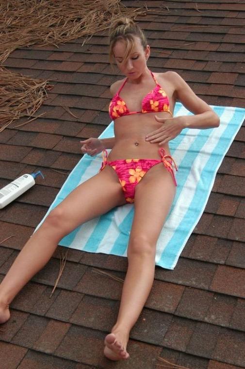 16P Brunette coed sun bathing on a roof