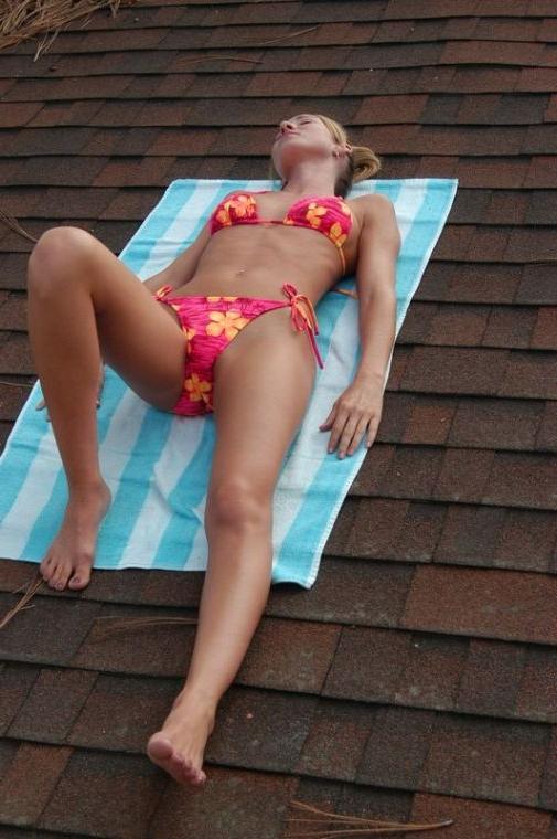 16P Brunette coed sun bathing on a roof