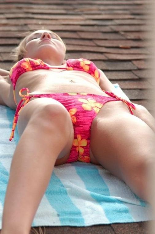 16P Brunette coed sun bathing on a roof