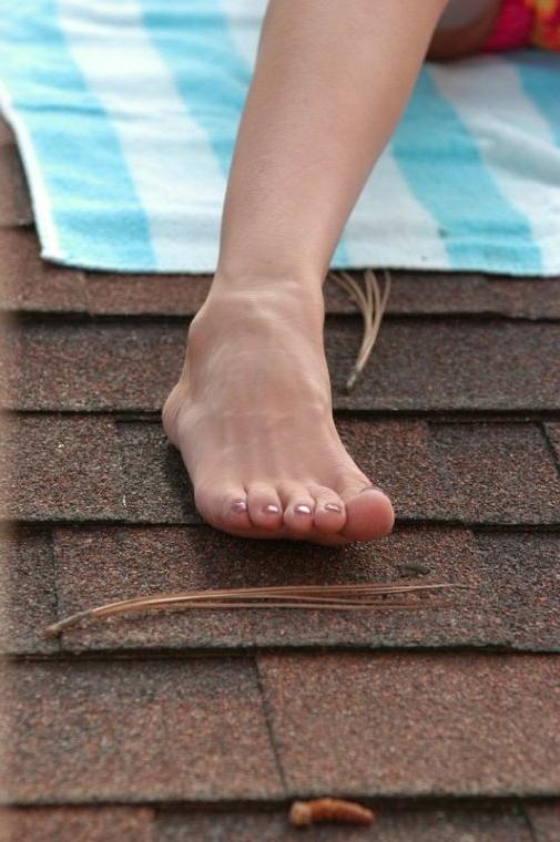 16P Brunette coed sun bathing on a roof
