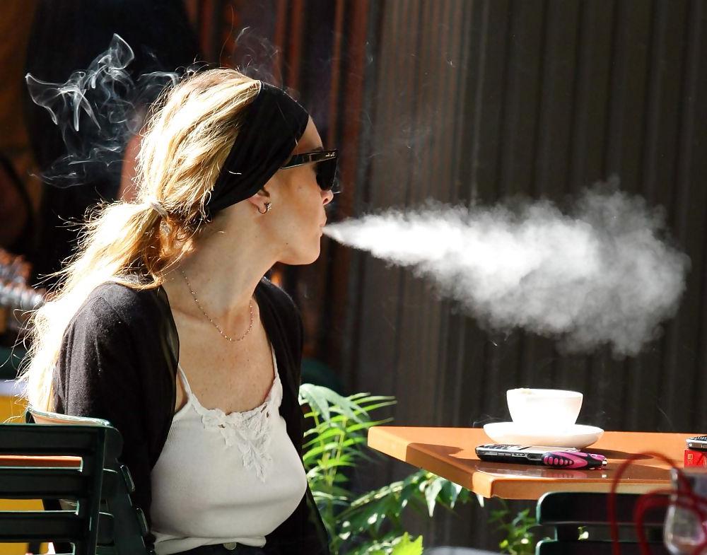 25P Lindsay Lohan is leggy smoking a cigarette in denim shorts