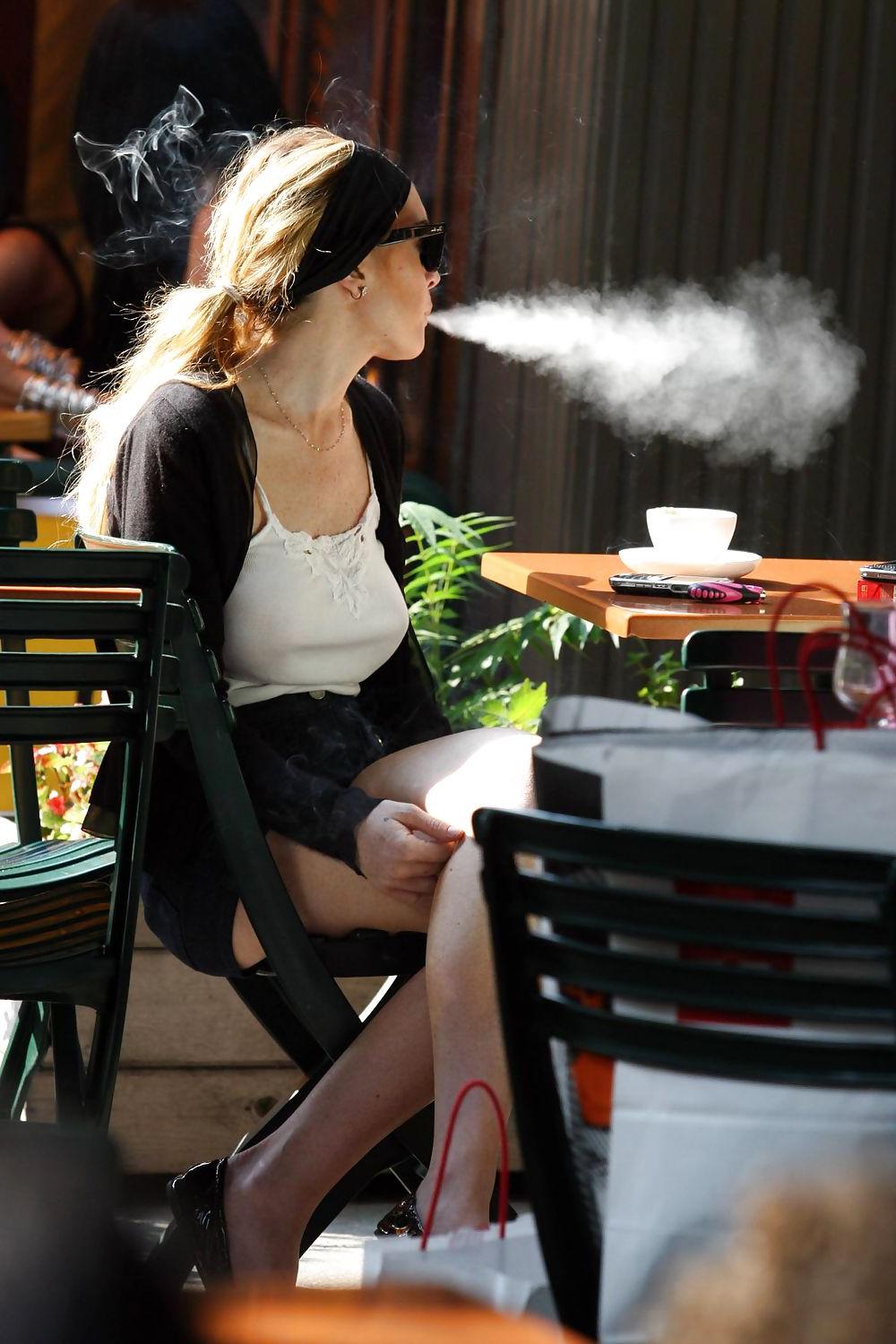 25P Lindsay Lohan is leggy smoking a cigarette in denim shorts