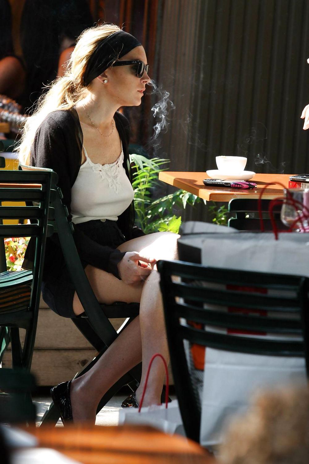 25P Lindsay Lohan is leggy smoking a cigarette in denim shorts