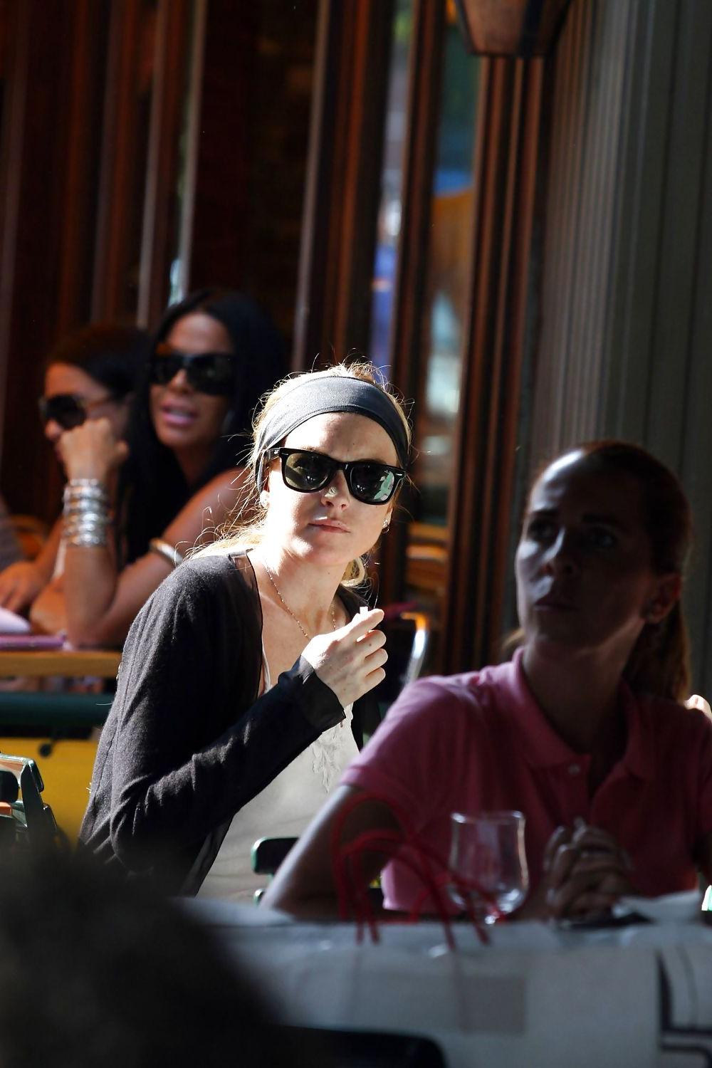 25P Lindsay Lohan is leggy smoking a cigarette in denim shorts