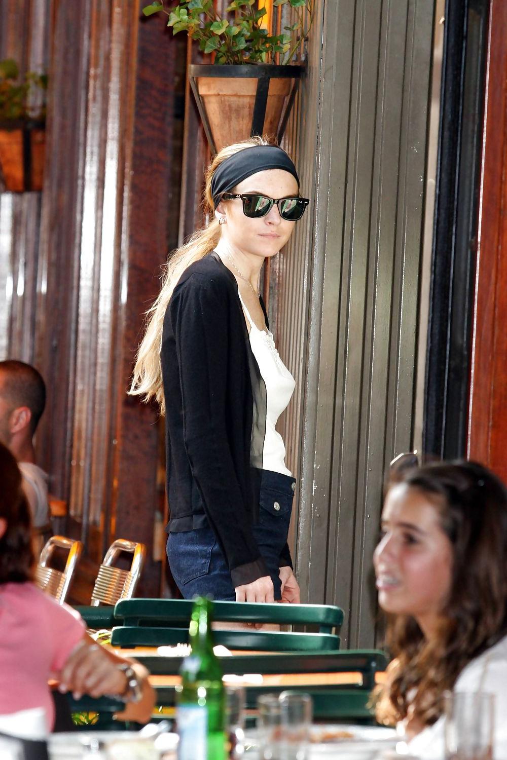 25P Lindsay Lohan is leggy smoking a cigarette in denim shorts