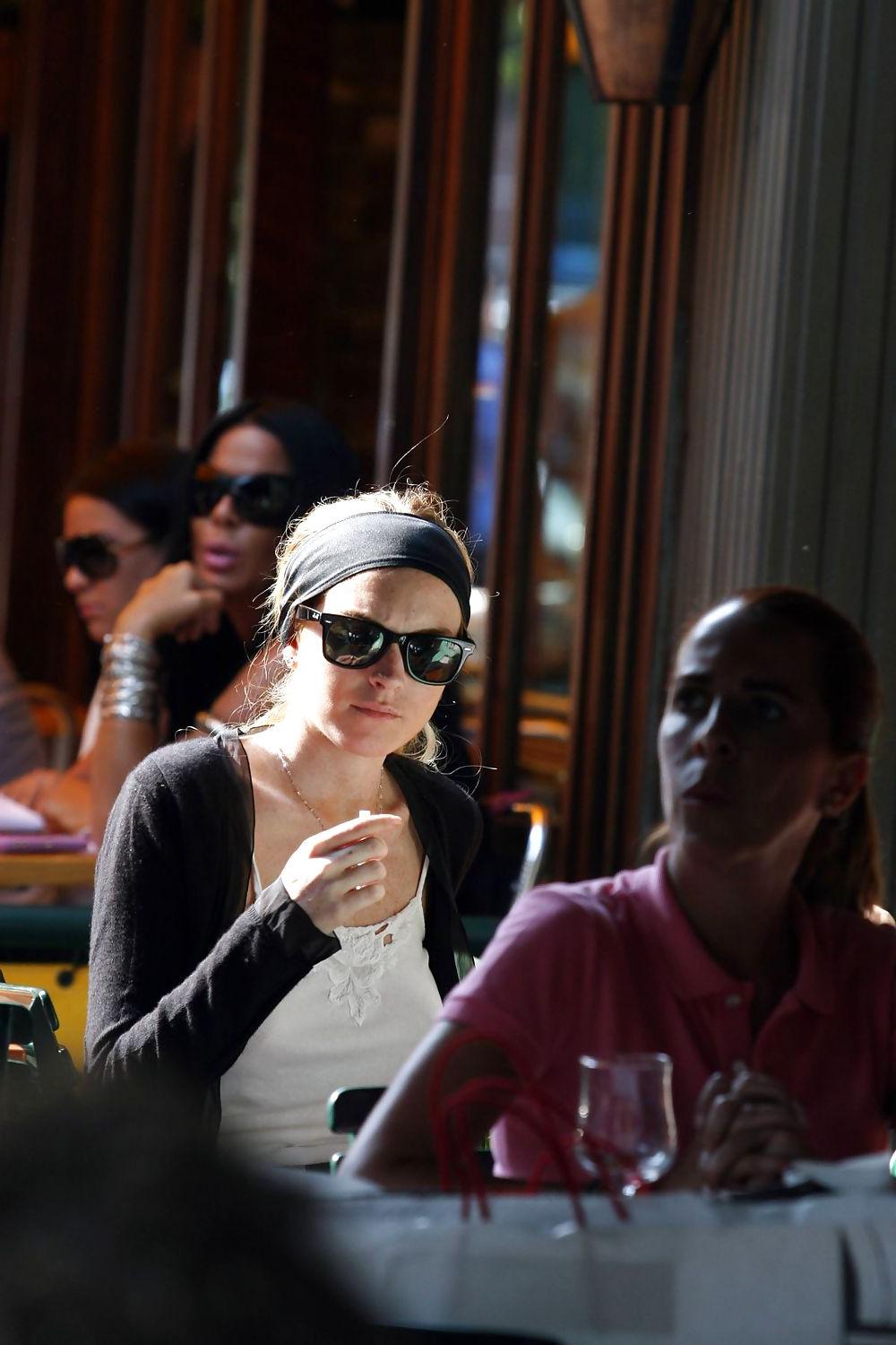 25P Lindsay Lohan is leggy smoking a cigarette in denim shorts