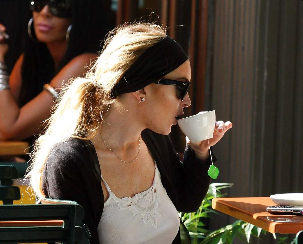 25P Lindsay Lohan is leggy smoking a cigarette in denim shorts