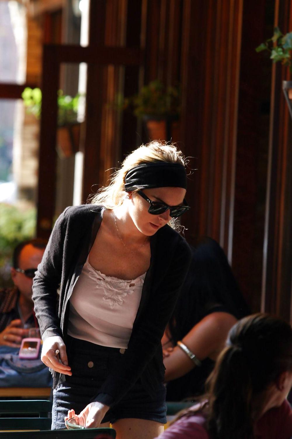 25P Lindsay Lohan is leggy smoking a cigarette in denim shorts