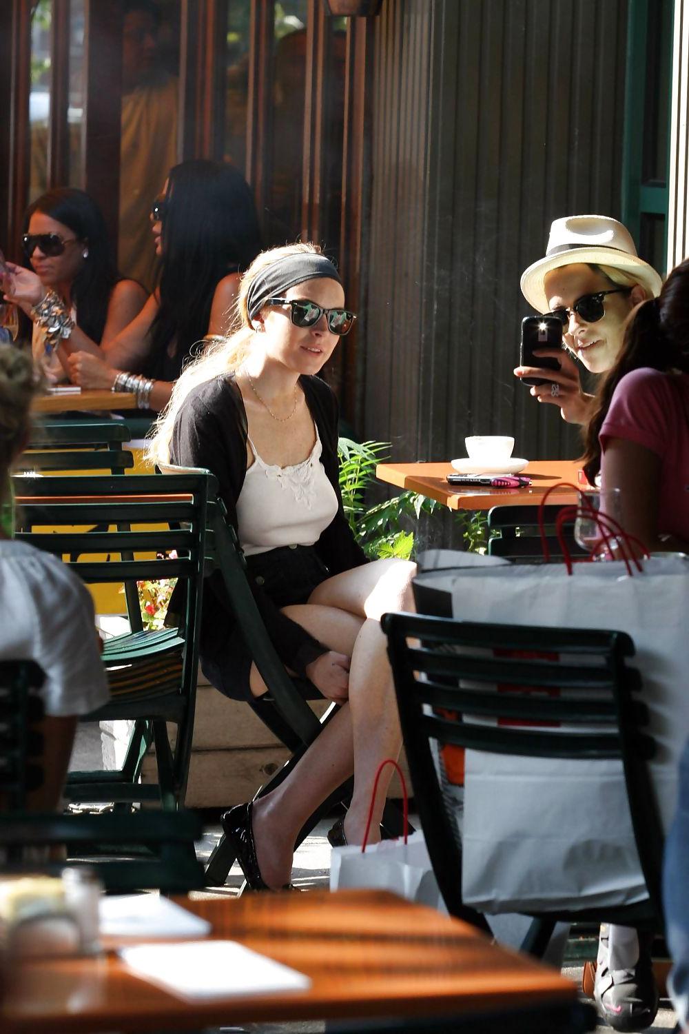 25P Lindsay Lohan is leggy smoking a cigarette in denim shorts