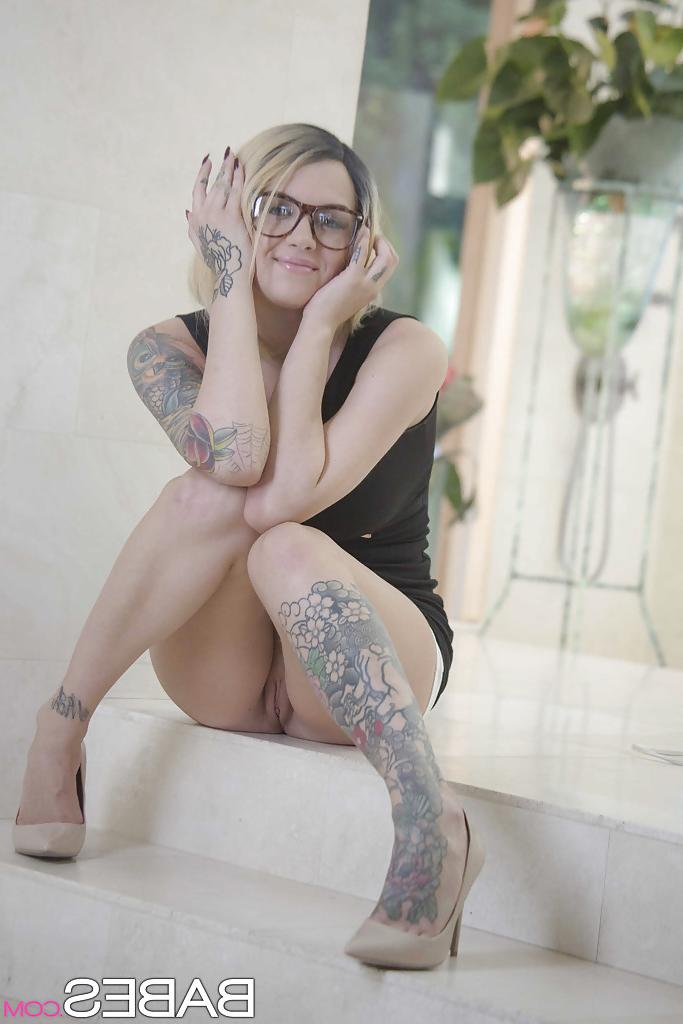 16P Inked babe in glasses revealing shaved pussy after shedding dress