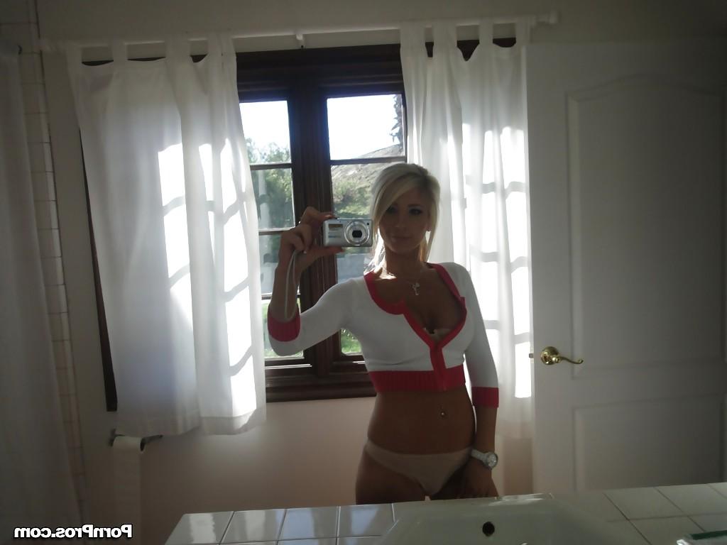 16P Blonde female Tasha Reign taking mirror self shots while removing her clothes