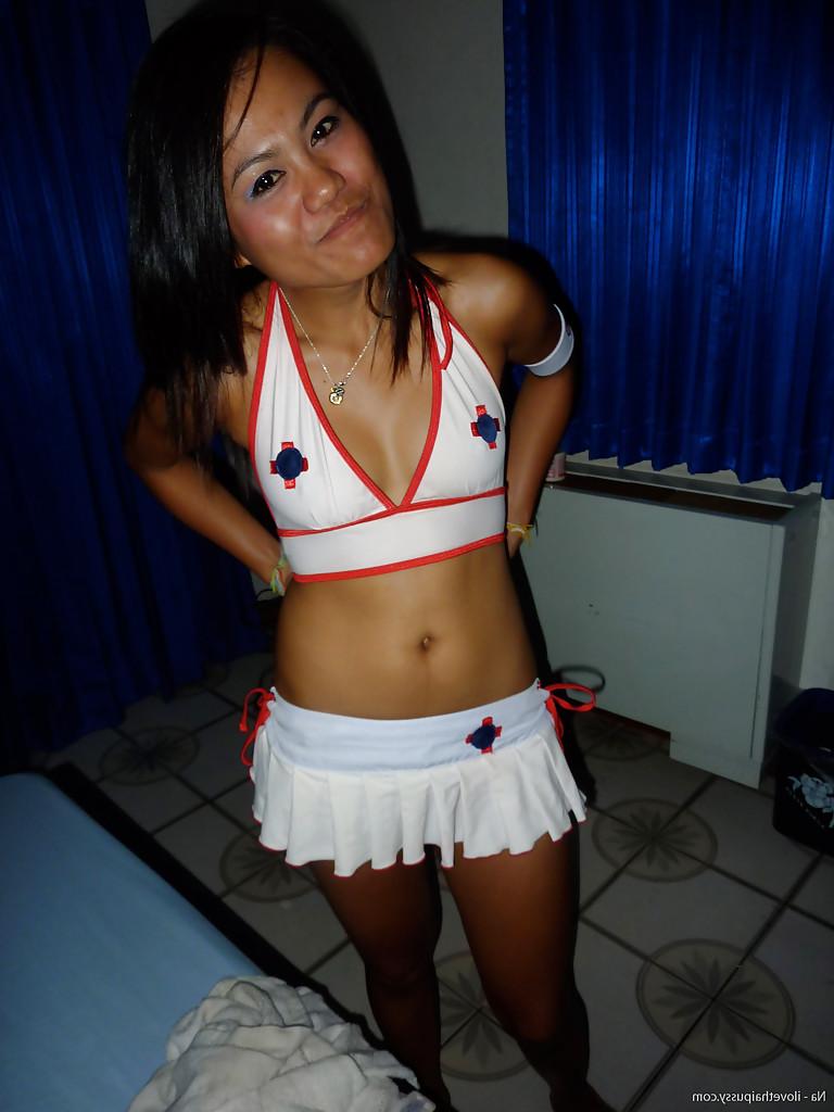 12P Thai female Tata posing naked on bed after peeling off socks and micro skirt